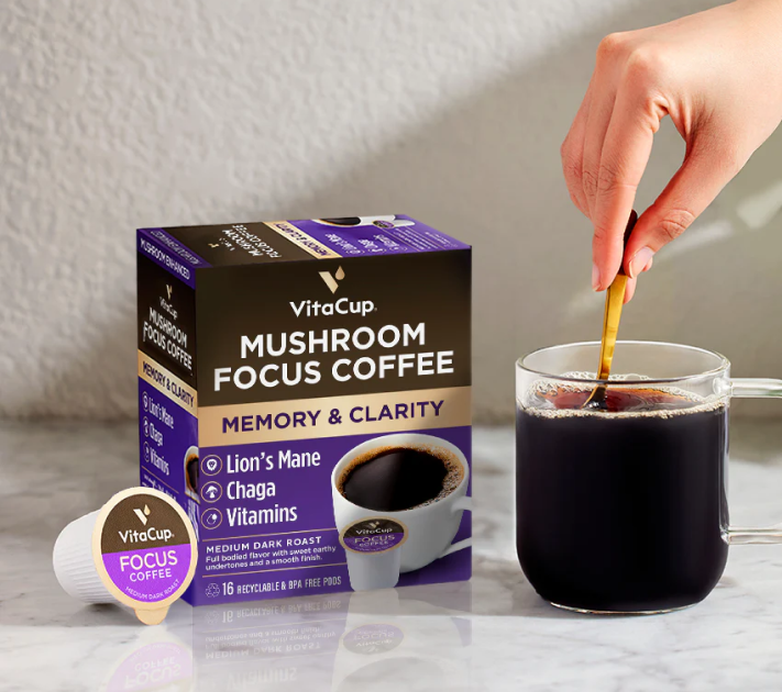VitaCup Mushroom Focus Coffee pods packaging with a hand pouring coffee into a glass.